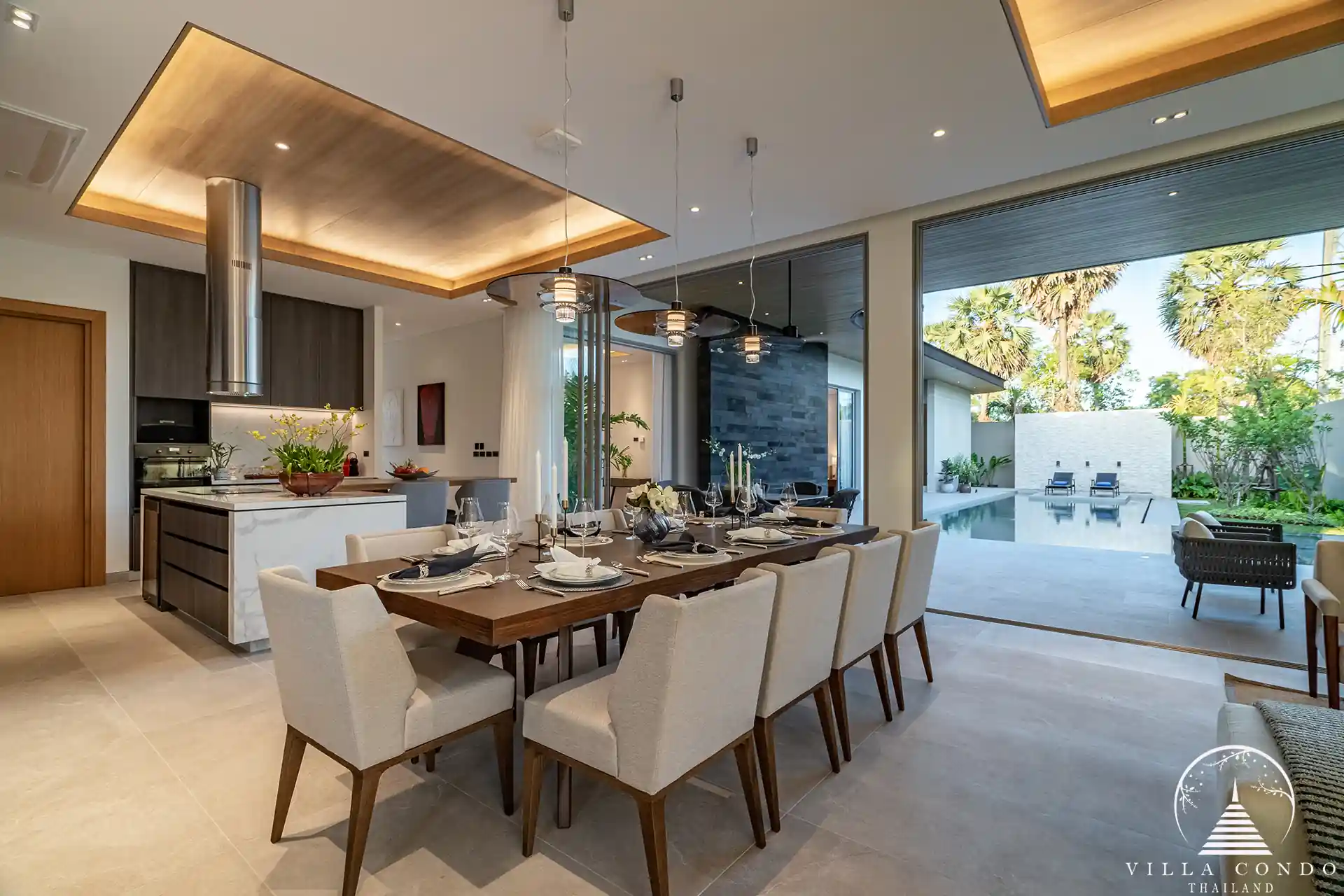 Elegant dining area at Alinda Villas with a modern table, stylish chairs, and ambient lighting.