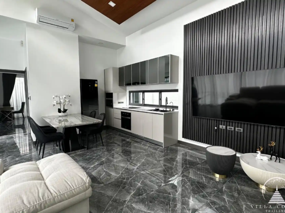 Elegant living area with plush sofa and entertainment setup.