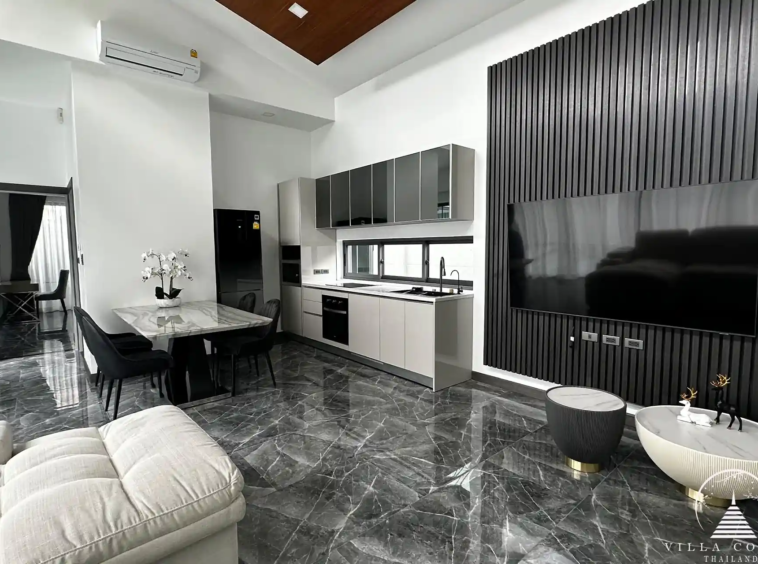 Elegant living area with plush sofa and entertainment setup.