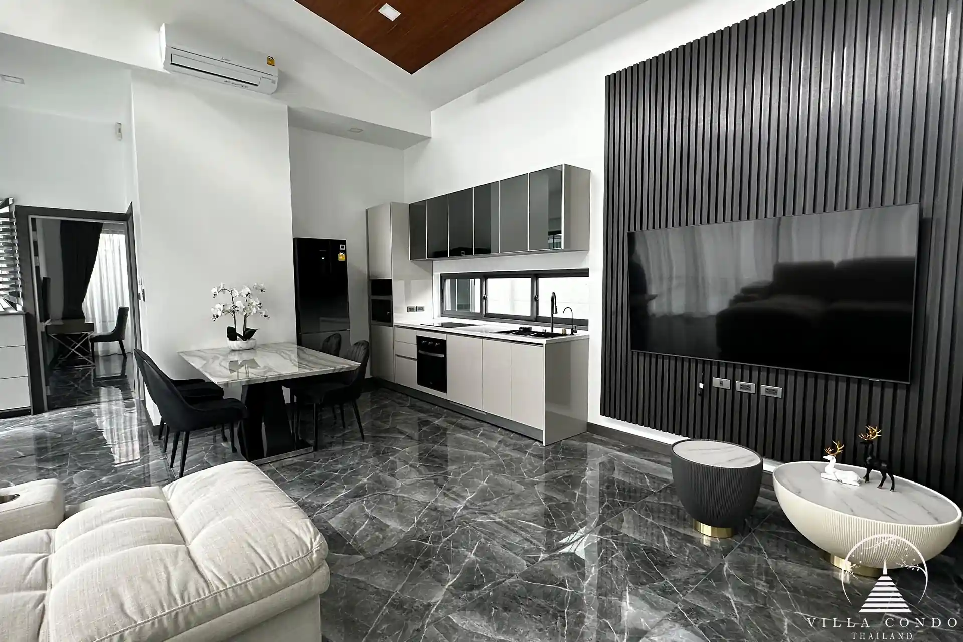 Elegant living area with plush sofa and entertainment setup.
