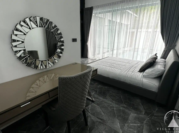 Spacious master bedroom with elegant decor and high ceilings.