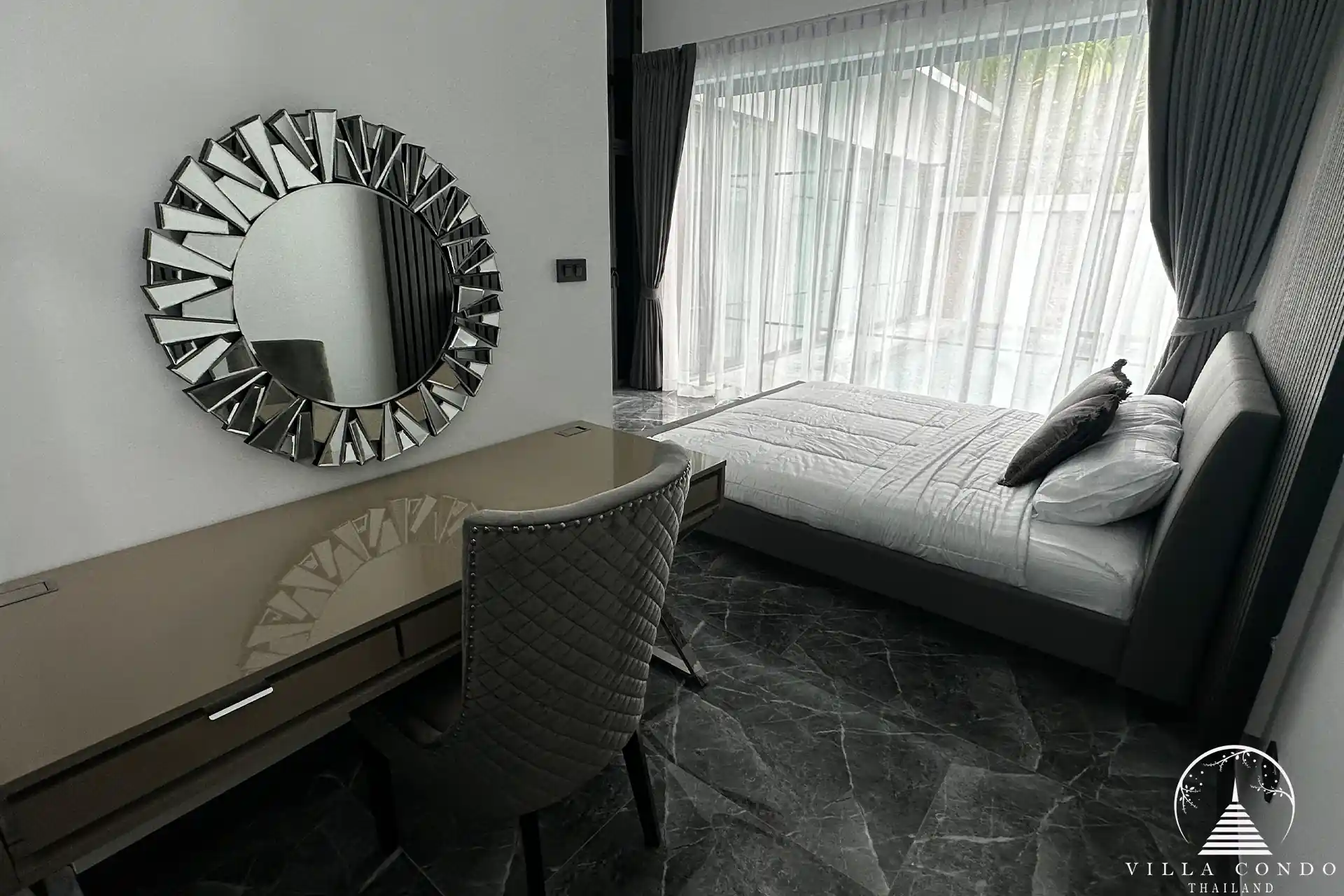 Spacious master bedroom with elegant decor and high ceilings.