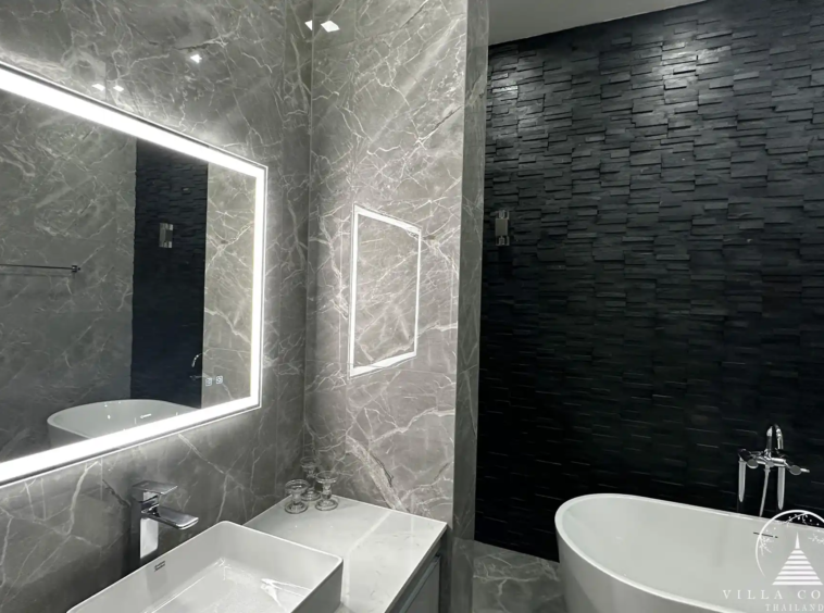 Elegant master bathroom with modern fixtures and natural light.