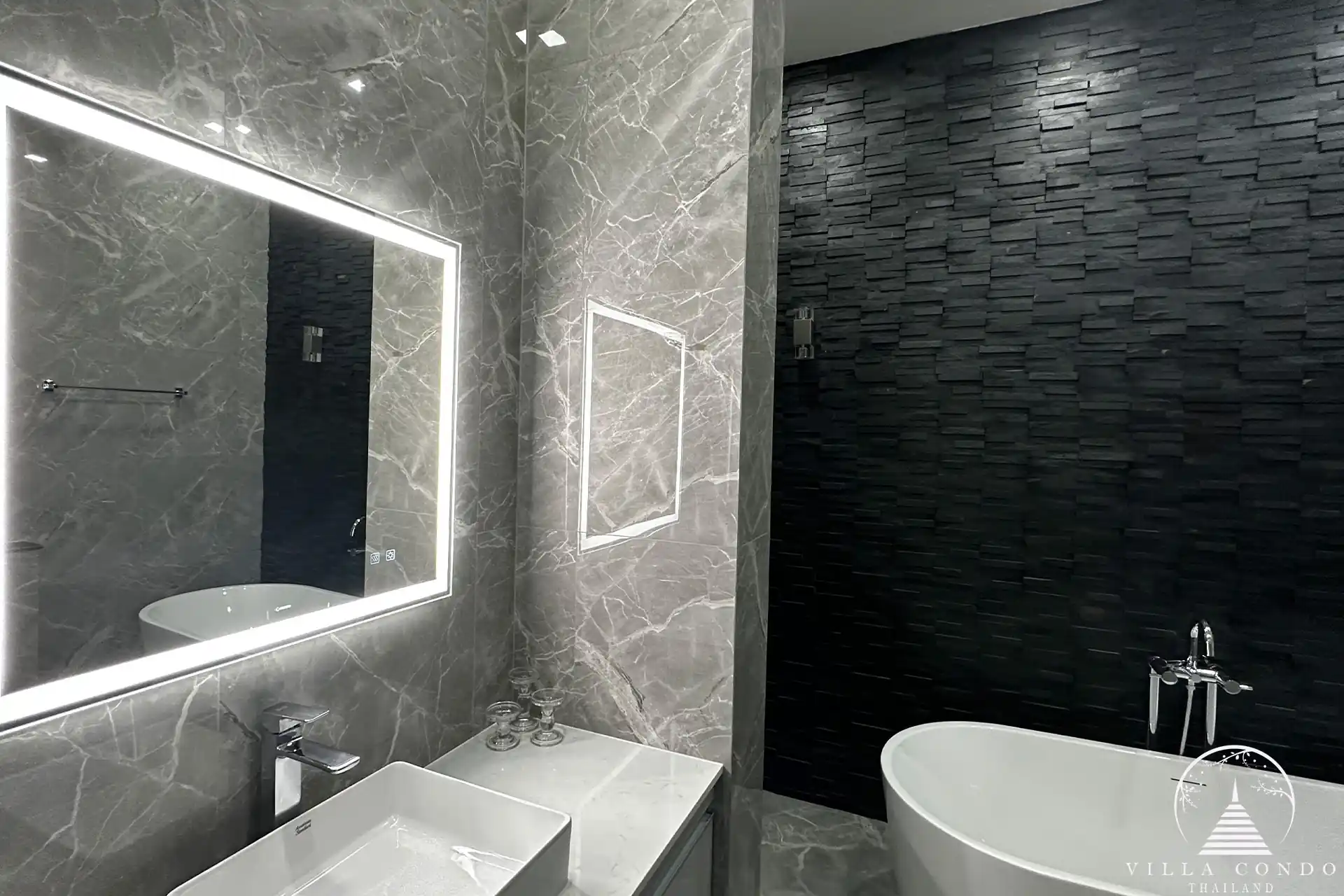 Elegant master bathroom with modern fixtures and natural light.