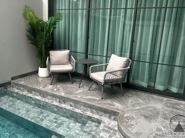 Outdoor lounge area with comfortable seating and lush garden.