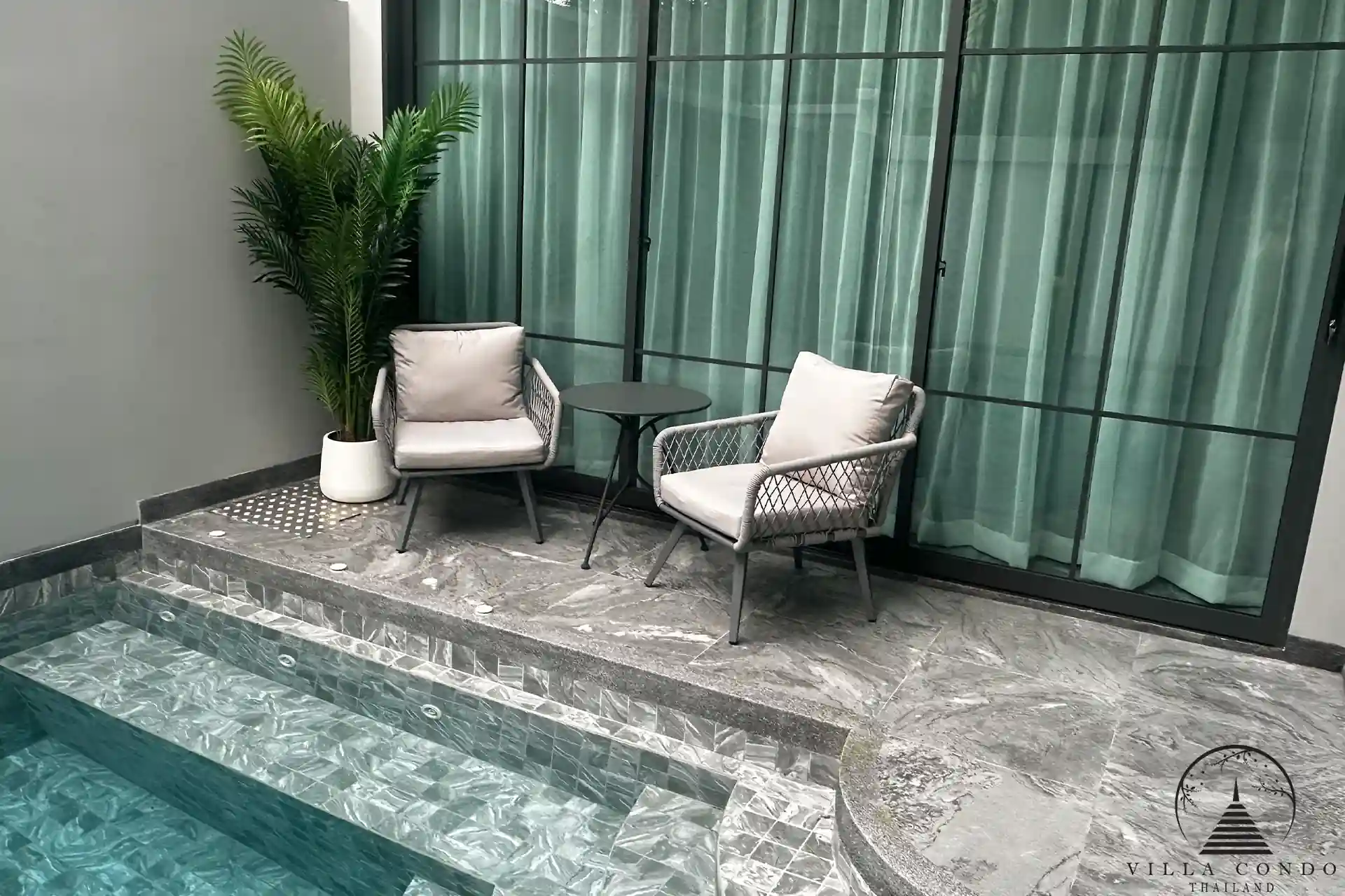 Outdoor lounge area with comfortable seating and lush garden.