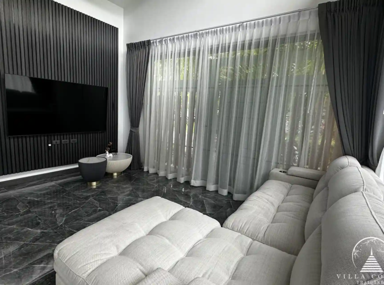 Elegant living area with plush sofa and entertainment setup.