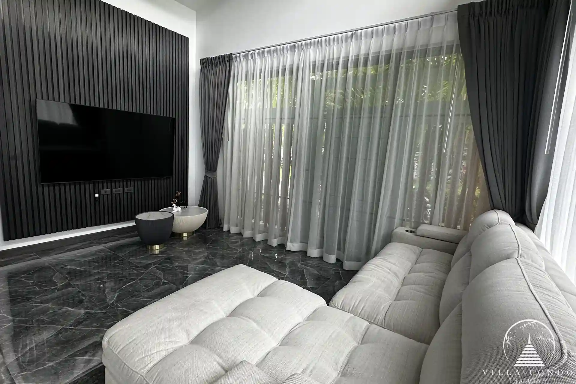 Elegant living area with plush sofa and entertainment setup.