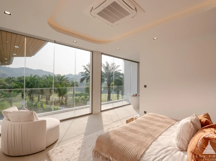 Luxurious bedroom with a view of the golf course in The PRIVA Golf Course Villa.
