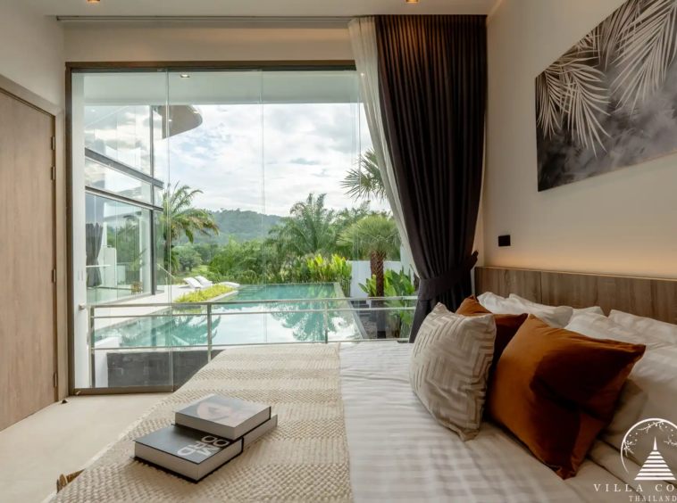 Luxurious bedroom with a view of the golf course in The PRIVA Golf Course Villa.