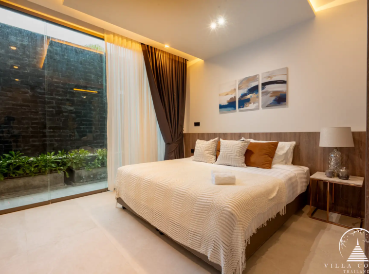 Luxurious bedroom with a view of the golf course in The PRIVA Golf Course Villa.