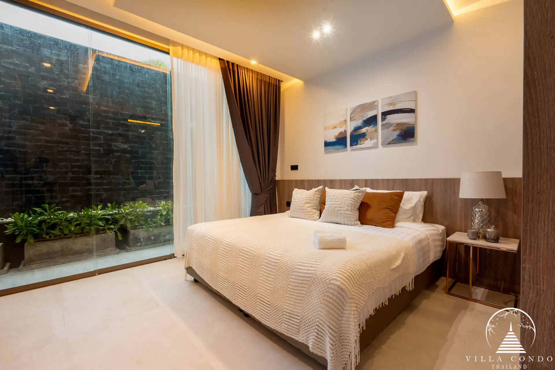 Luxurious bedroom with a view of the golf course in The PRIVA Golf Course Villa.