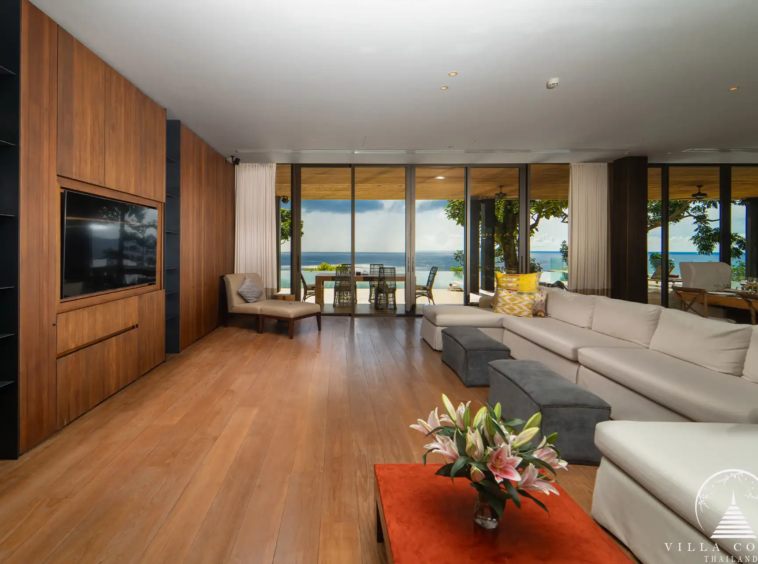 Spacious living area in Villa Amarisa with an L-shaped sofa and ocean views.