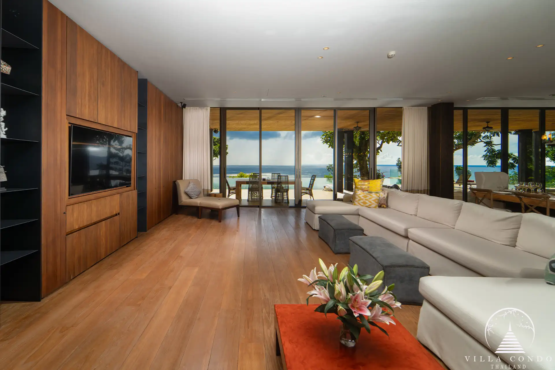 Spacious living area in Villa Amarisa with an L-shaped sofa and ocean views.