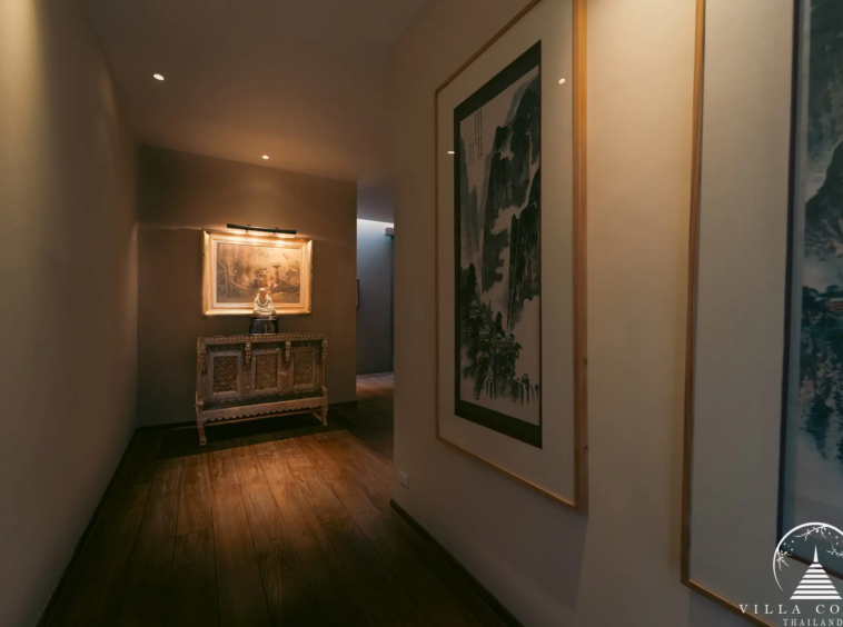 Villa Amarisa corridor with sandstone walls and polished teak hardwood floors.