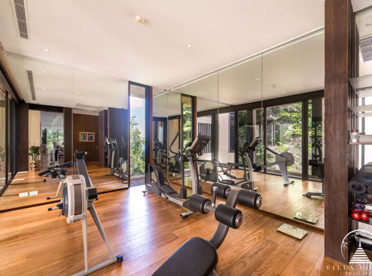 Private fitness gym in Villa Amarisa with modern equipment and yoga mats.