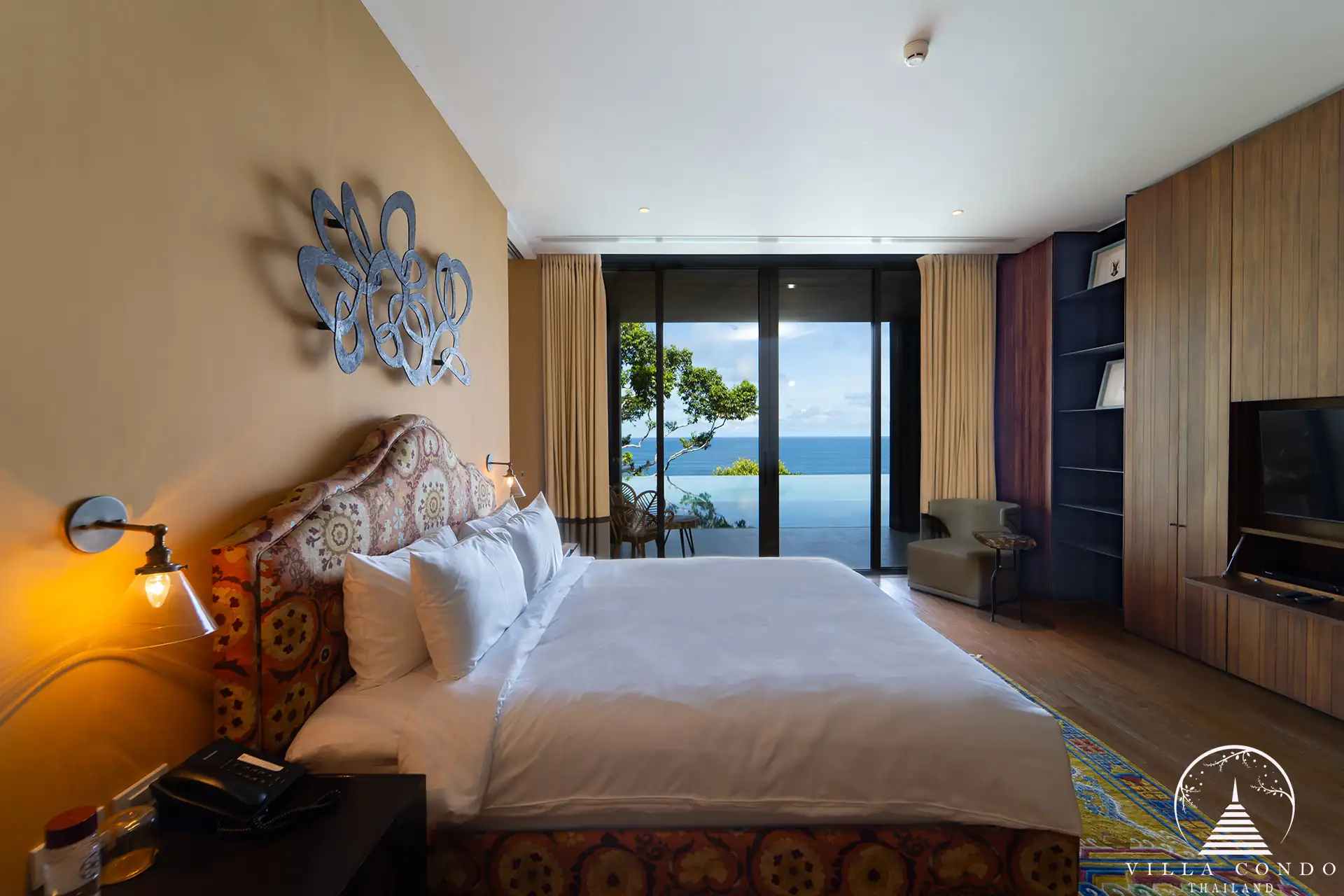 Master bedroom at Villa Amarisa with panoramic sea views and a private balcony.