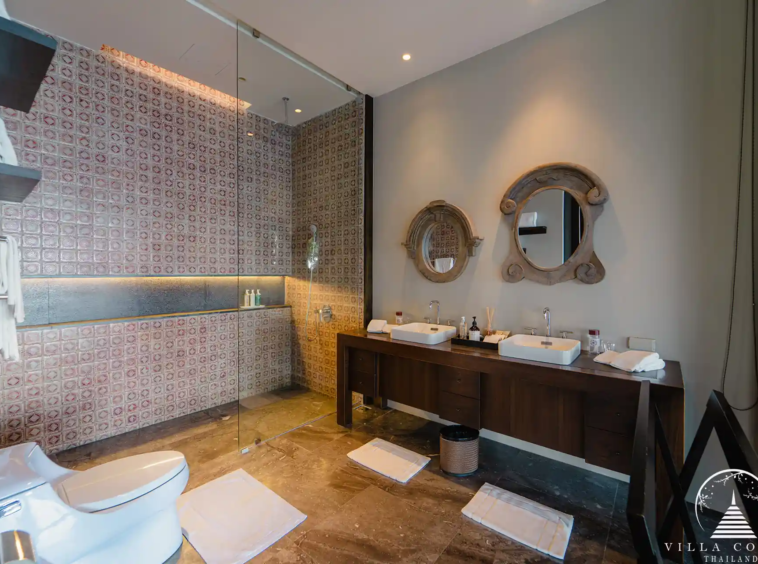 Elegant master bathroom in Villa Amarisa with a Moroccan-tiled shower and double vanity.