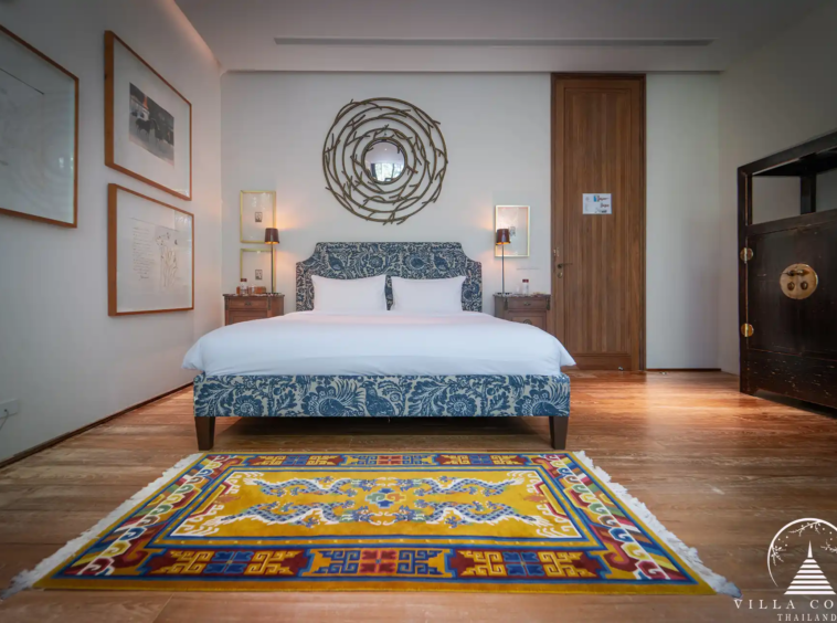 Luxurious bedroom in Villa Amarisa with wooden floors and a private balcony.