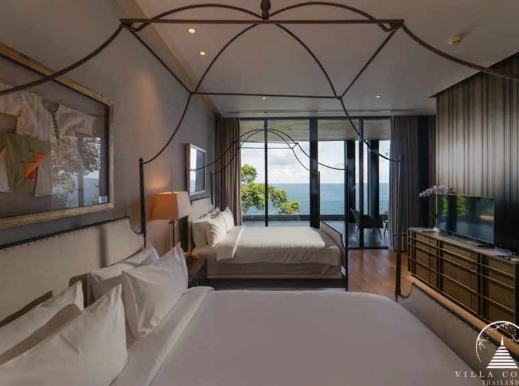 Guest bedroom in Villa Amarisa with wooden floors and a garden-view balcony.