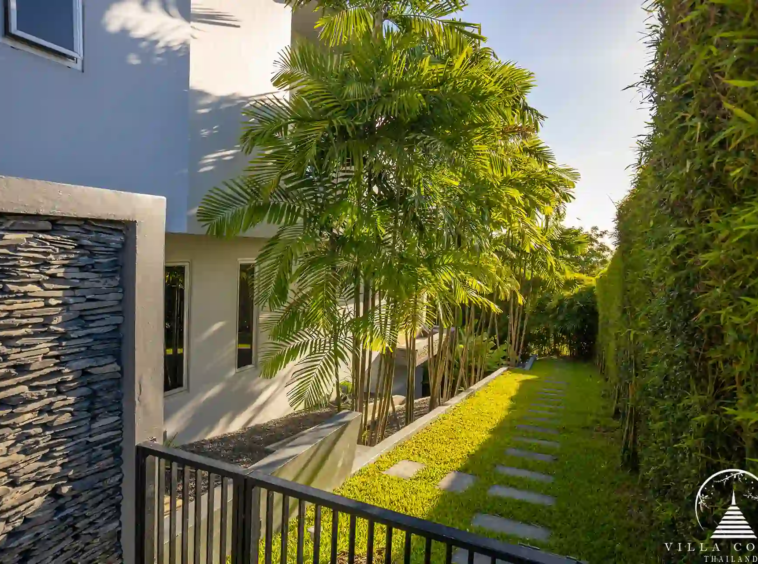 Lush garden area at Villa Nova at Layan Hillside with tropical landscaping and seating.