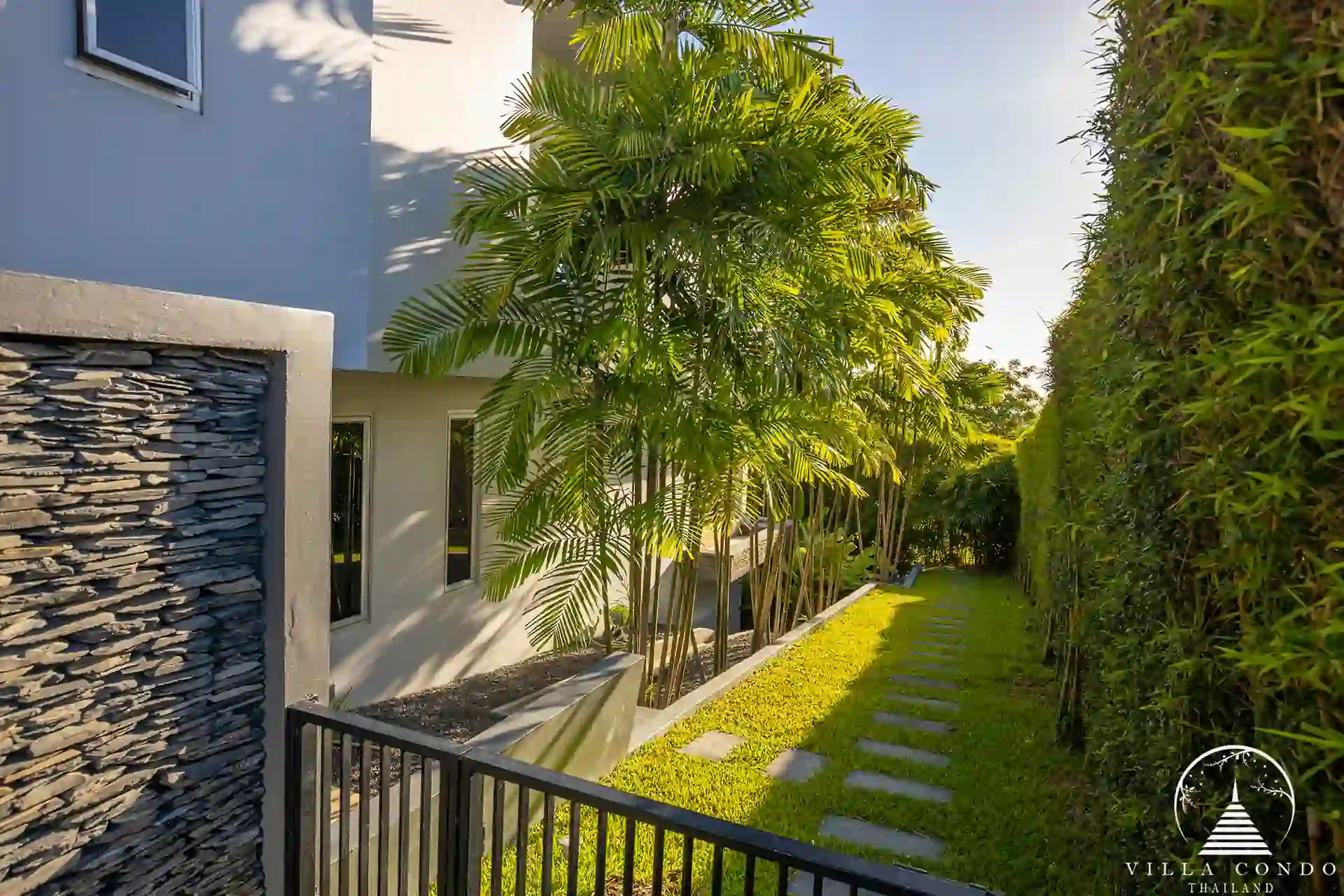 Lush garden area at Villa Nova at Layan Hillside with tropical landscaping and seating.