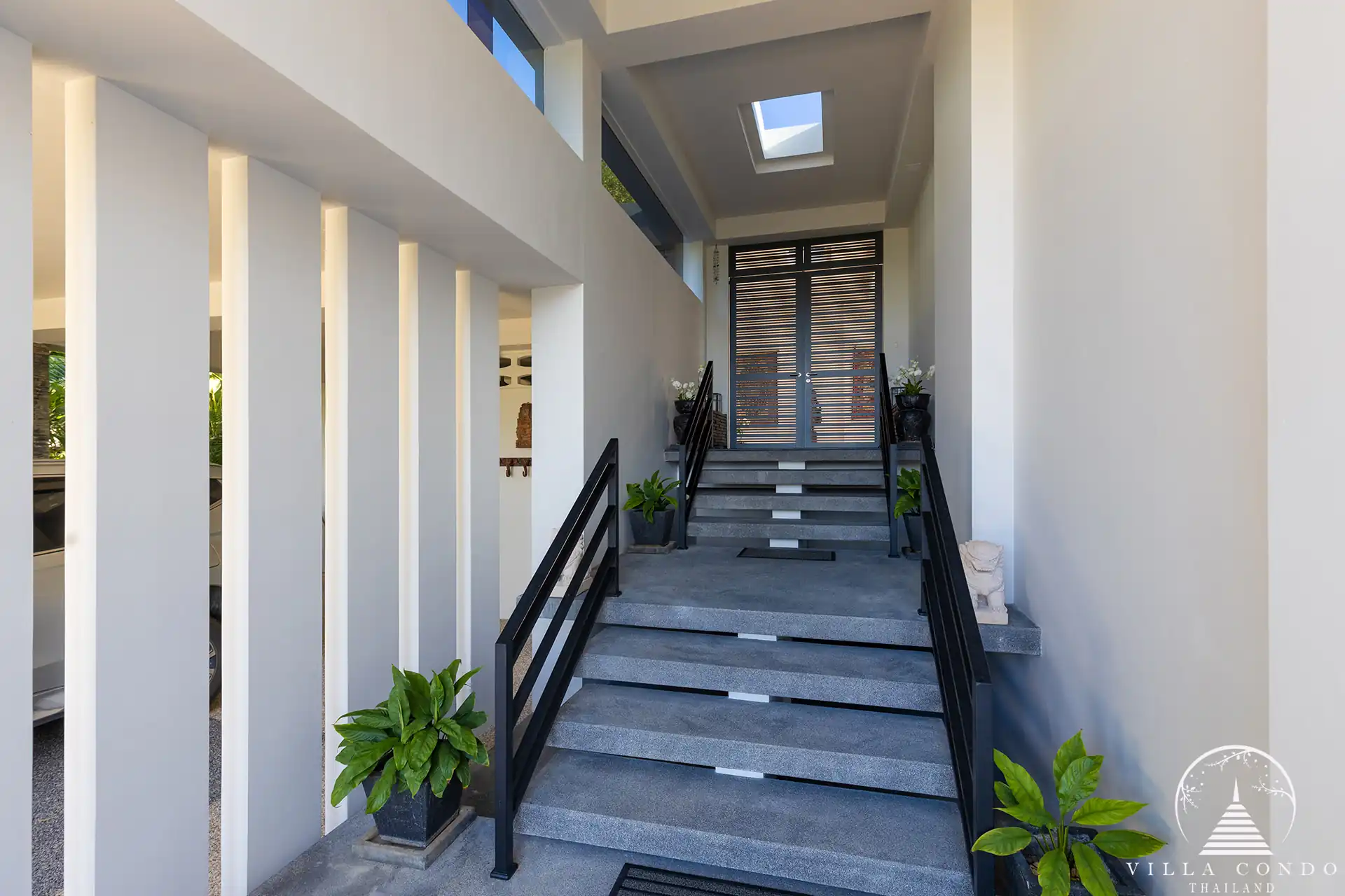 Elegant entrance of Villa Nova at Layan Hillside with natural stone and wood features.