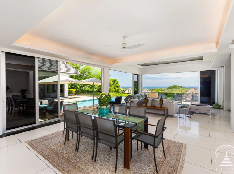 Open-plan dining area in Villa Nova at Layan Hillside with elegant furnishings and ocean views.