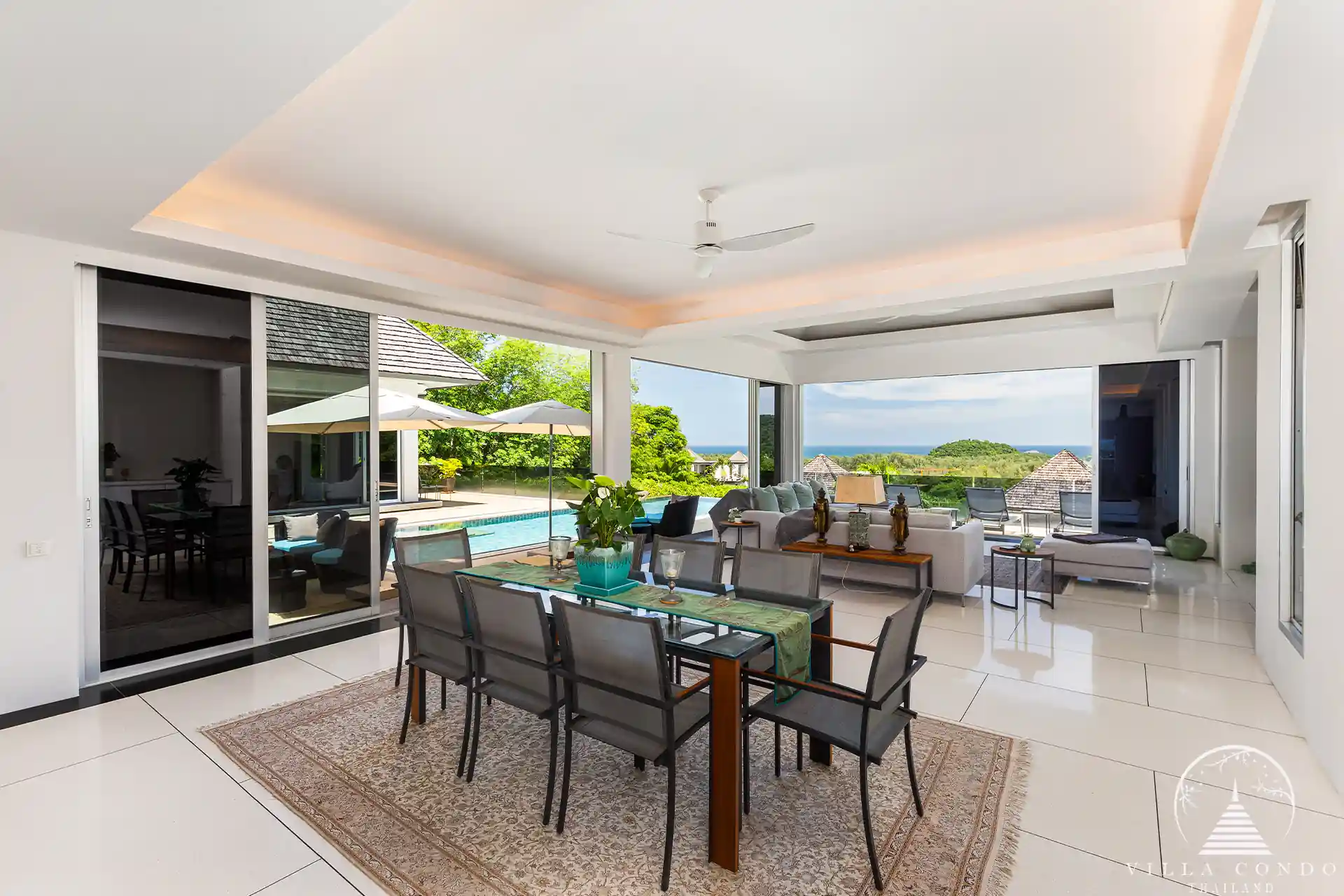 Open-plan dining area in Villa Nova at Layan Hillside with elegant furnishings and ocean views.