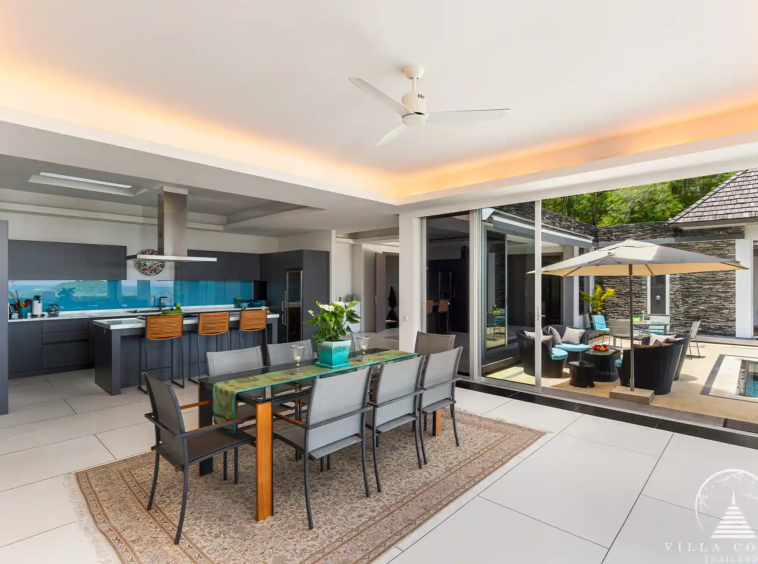 Open-plan dining area in Villa Nova at Layan Hillside with elegant furnishings and ocean views.