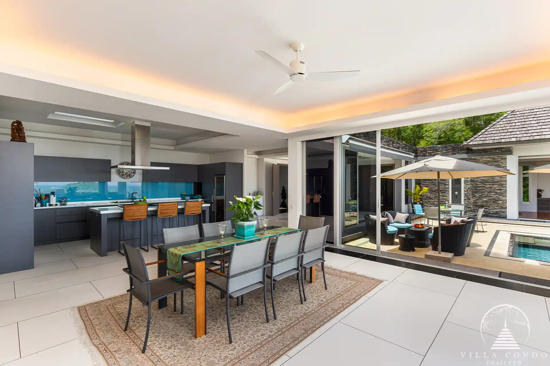 Open-plan dining area in Villa Nova at Layan Hillside with elegant furnishings and ocean views.