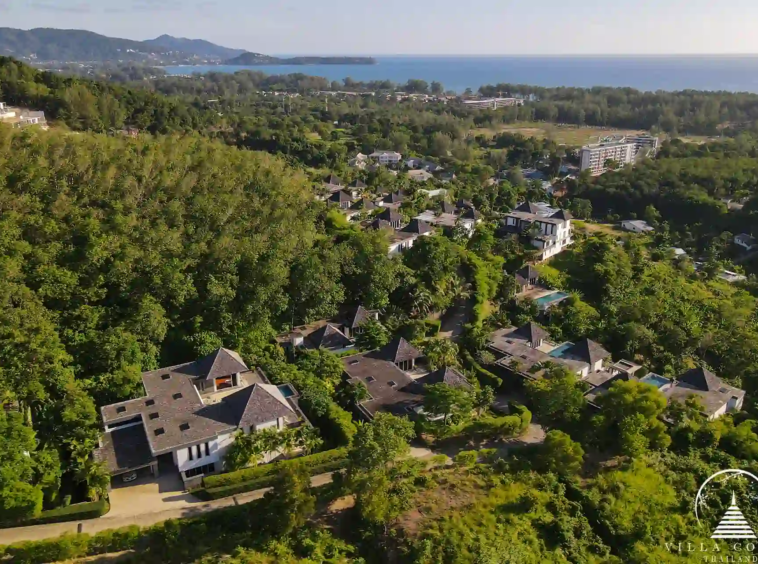 Bird’s eye view of Villa Nova at Layan Hillside and its surrounding lush landscape.