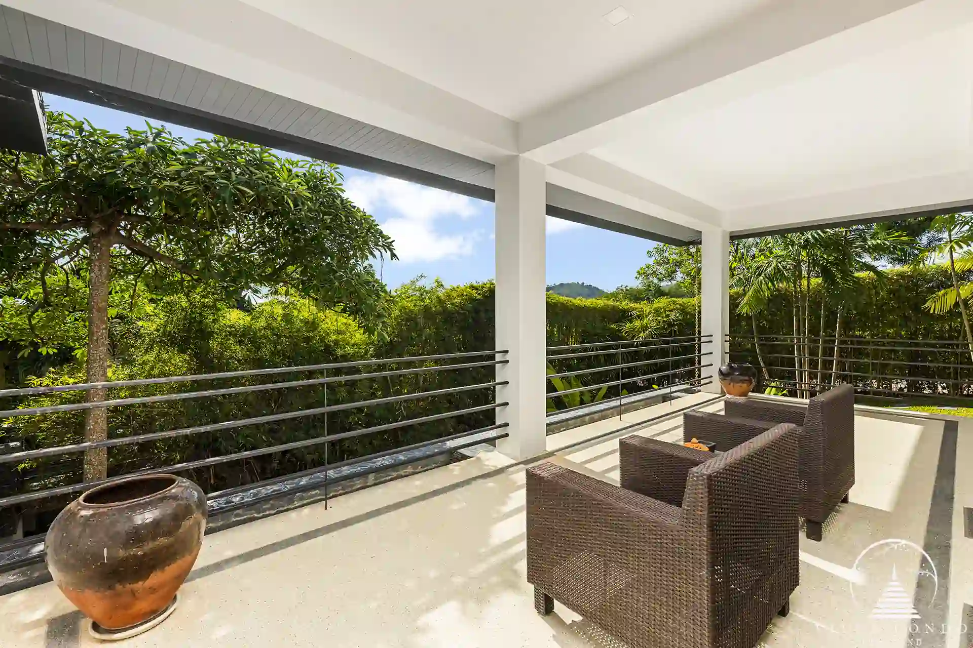 Roofed balcony at Villa Nova at Layan Hillside with ocean views and comfortable seating.