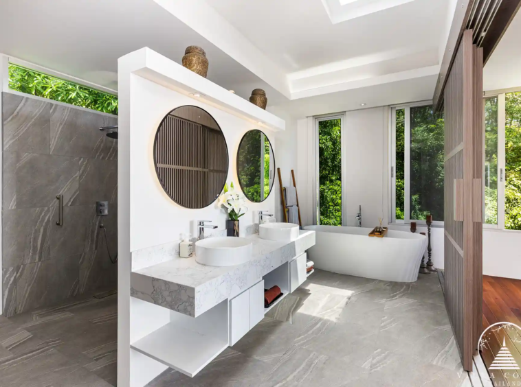 Master bathroom at Villa Nova at Layan Hillside with natural stone finishes and luxury amenities.