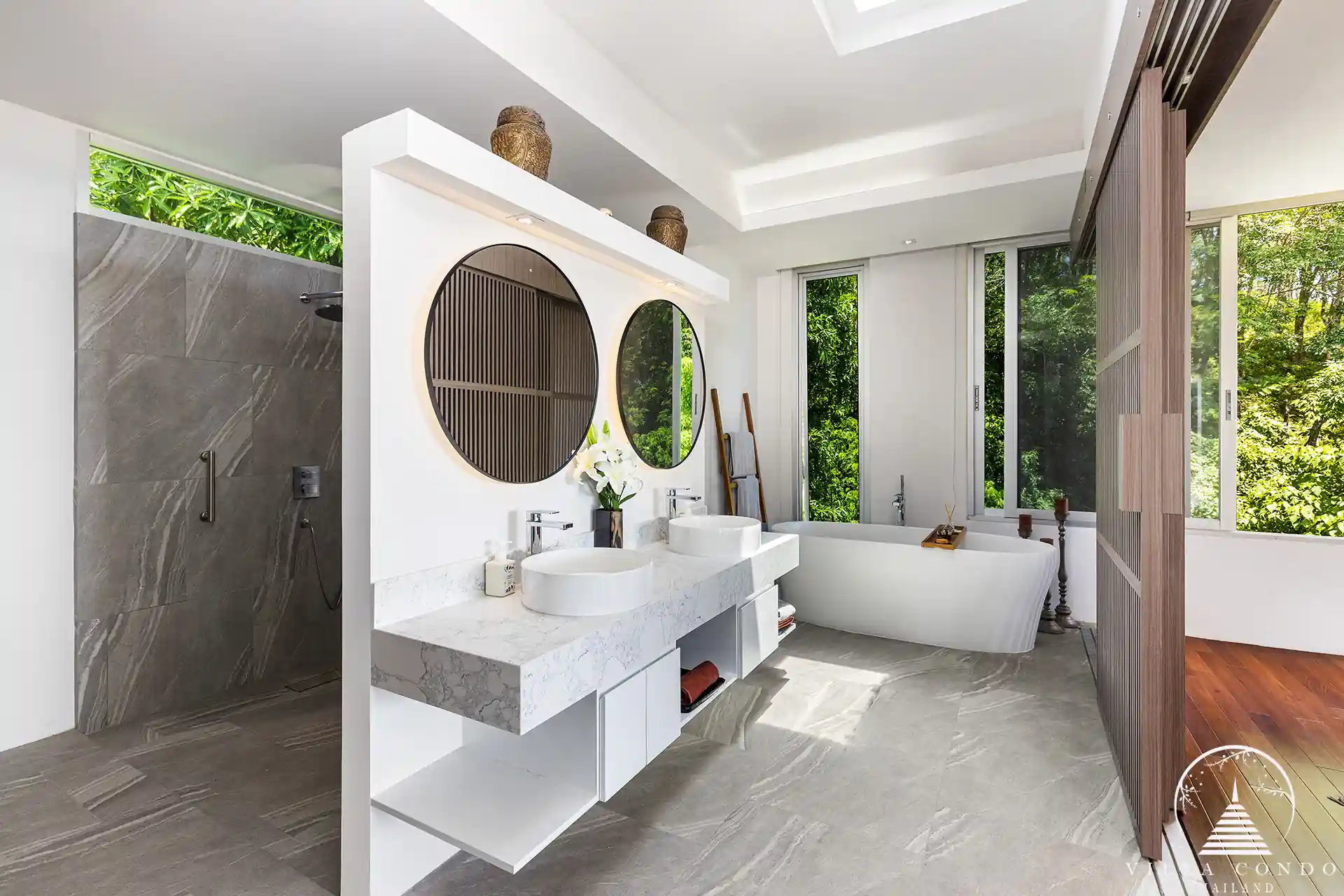 Master bathroom at Villa Nova at Layan Hillside with natural stone finishes and luxury amenities.