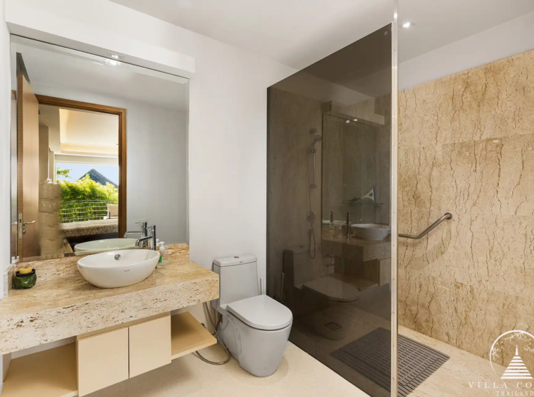 Modern bathroom in Villa Nova at Layan Hillside with natural stone accents and luxury fixtures.