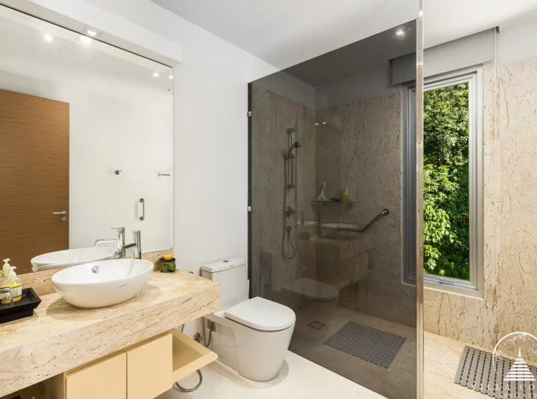 Modern bathroom in Villa Nova at Layan Hillside with natural stone accents and luxury fixtures.