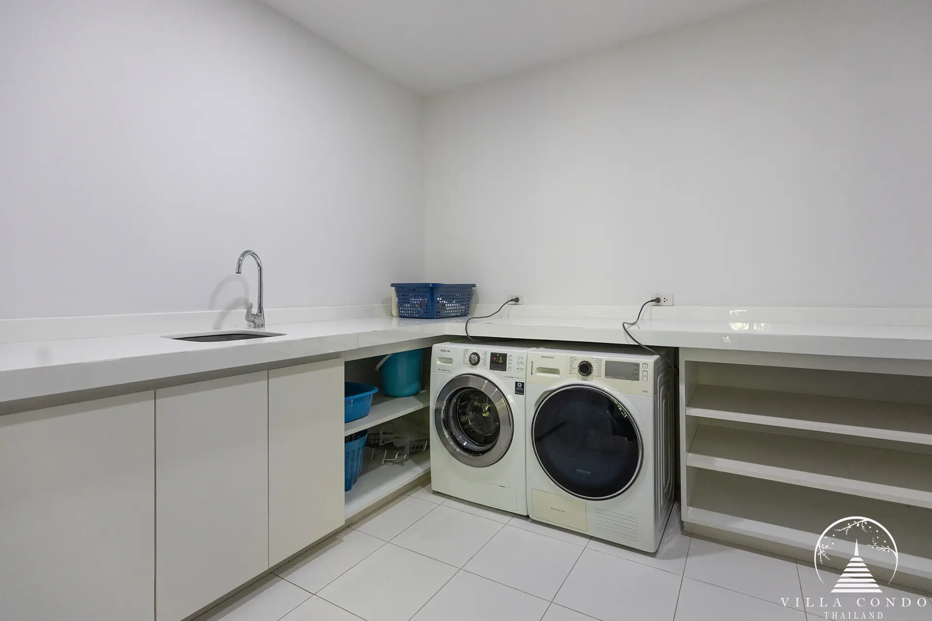 Functional laundry room at Villa Nova at Layan Hillside with modern appliances.