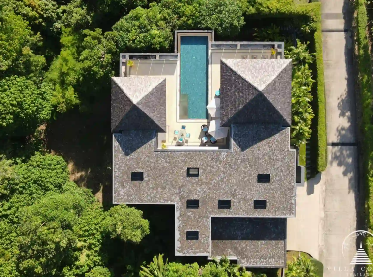 Bird’s eye view of Villa Nova at Layan Hillside and its surrounding lush landscape.