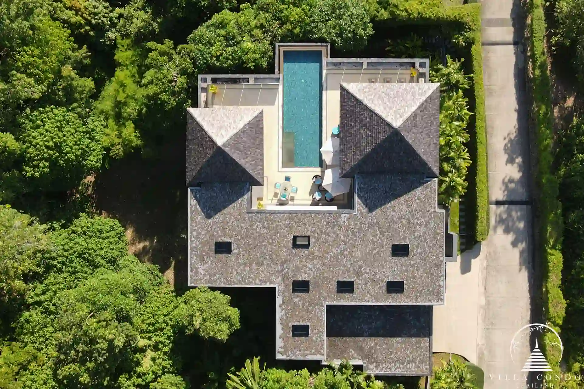 Bird’s eye view of Villa Nova at Layan Hillside and its surrounding lush landscape.