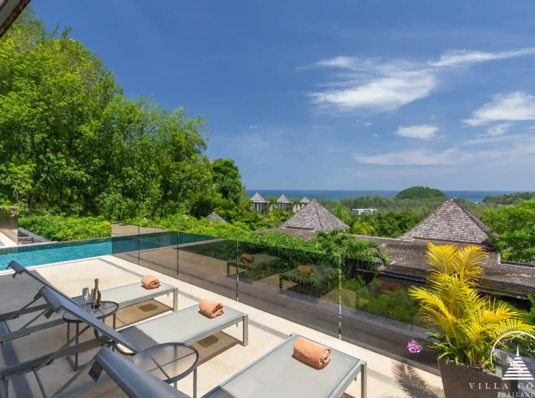 Sunbed area by the pool at Villa Nova at Layan Hillside with panoramic sea views.