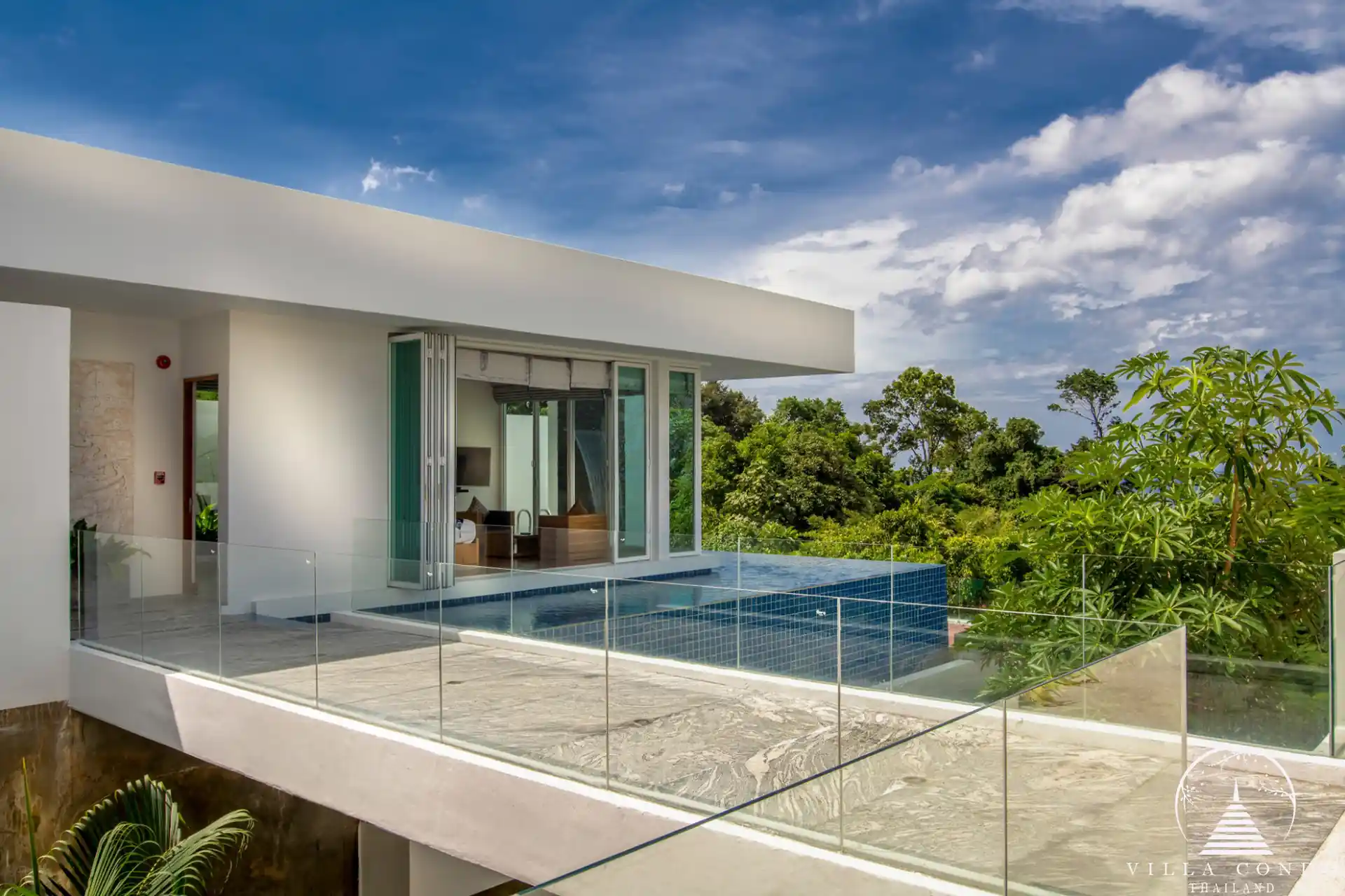 Outdoor area with a private pool and seating at Villa Solaris Kamala.