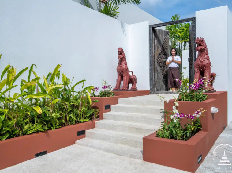 Side entrance to Villa Solaris Kamala with lush landscaping.