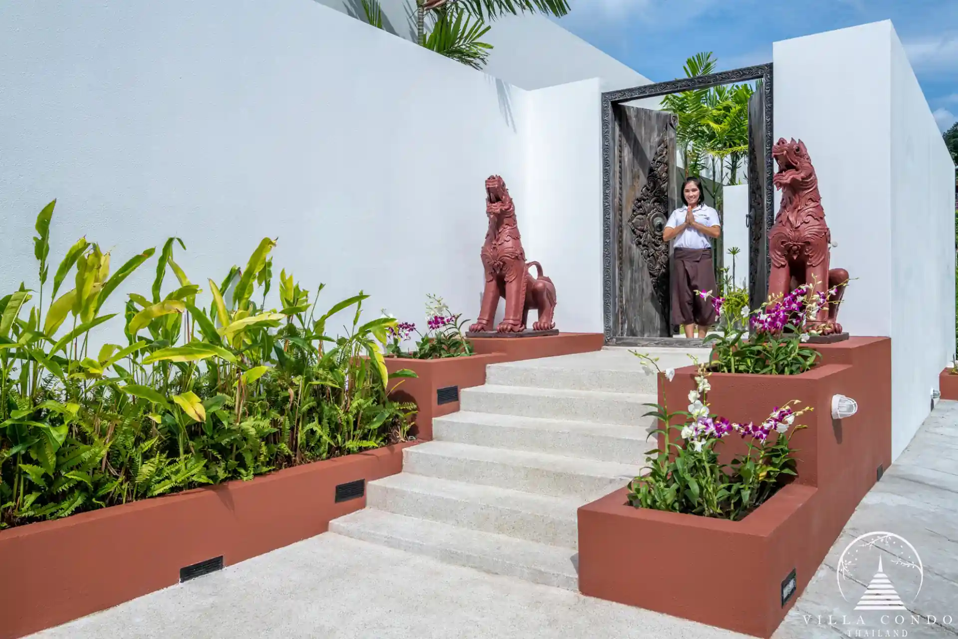 Side entrance to Villa Solaris Kamala with lush landscaping.
