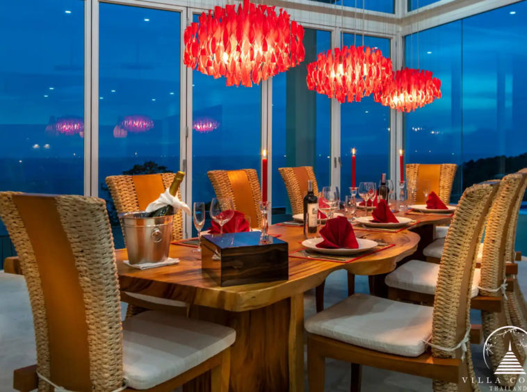 Elegant dining area with modern furnishings and ocean views at Villa Solaris Kamala.