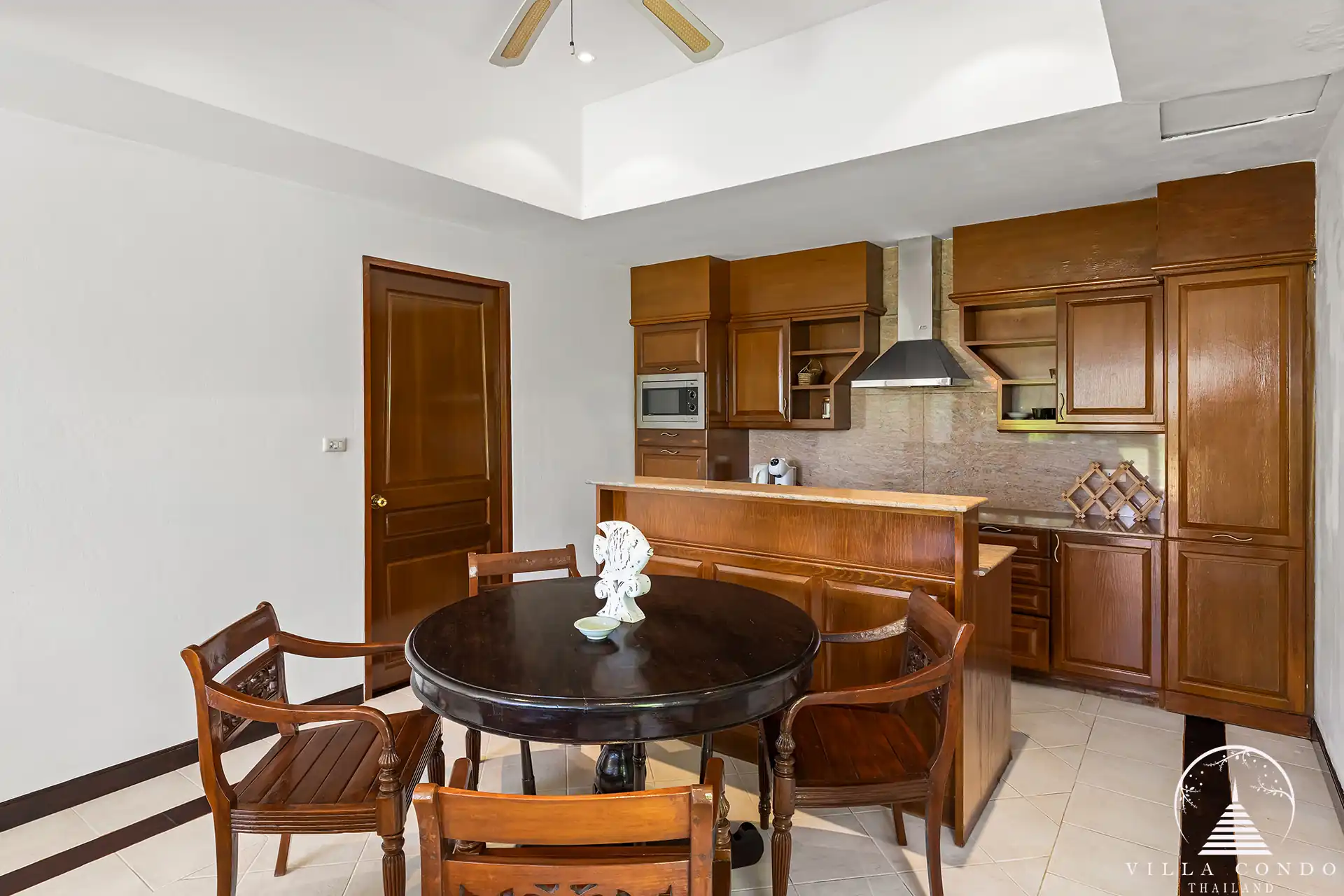 Thai-style interior design at Nakathani Villa Estate Kamala Beach with wooden accents and spacious living areas.