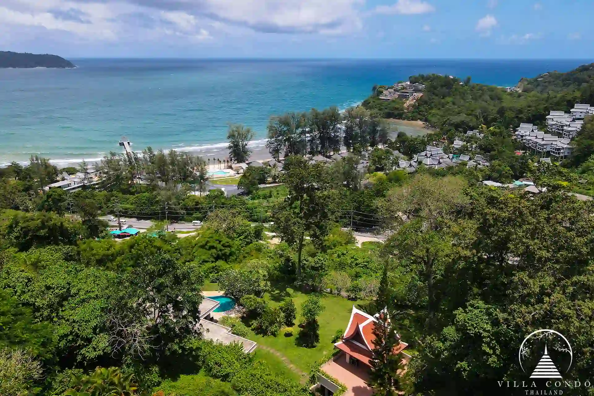 Exterior view of Nakathani Villa Estate Kamala Beach with a sea view in the background.