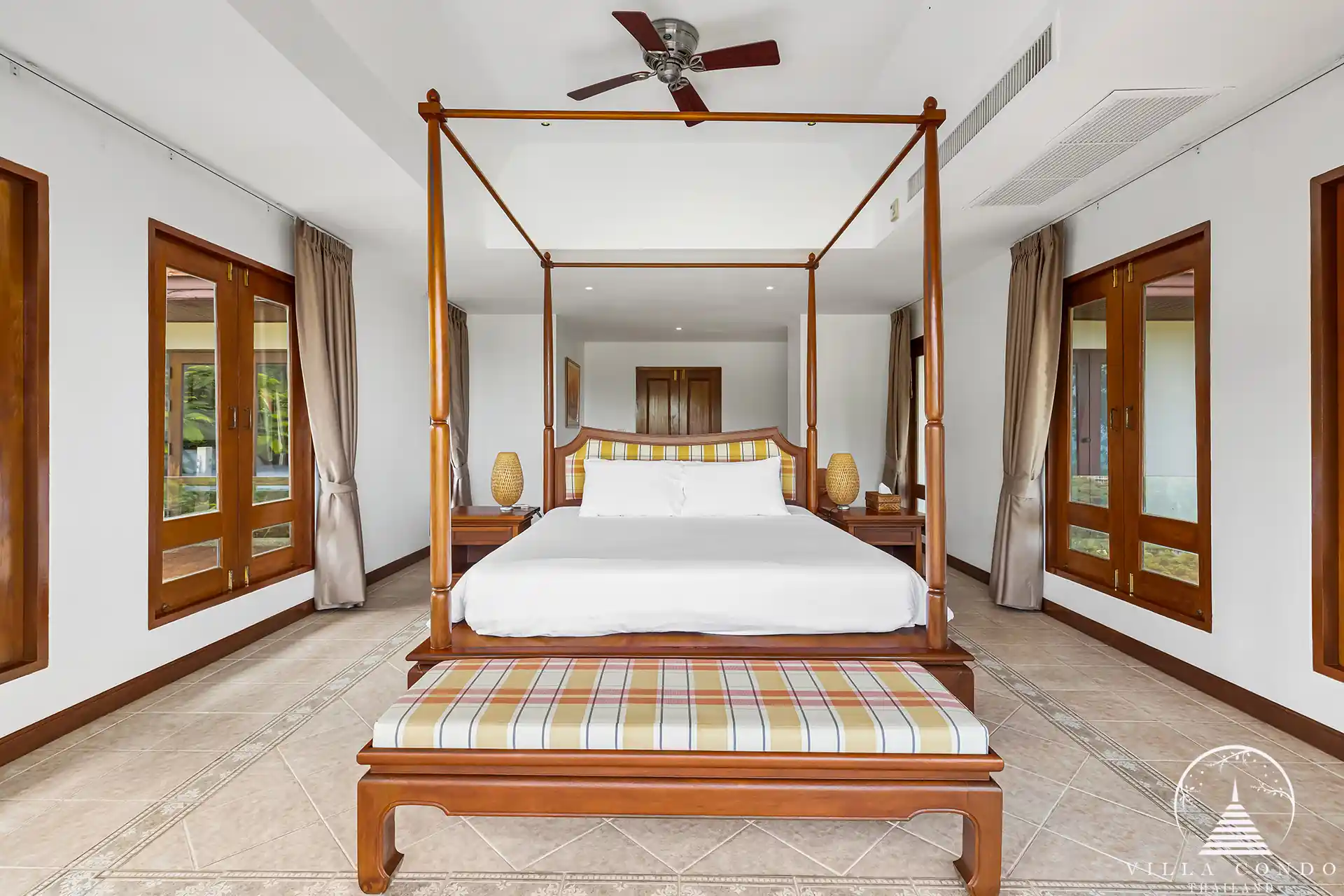 Elegant guest bedroom at Nakathani Villa Estate Kamala Beach with ocean views and luxurious decor.