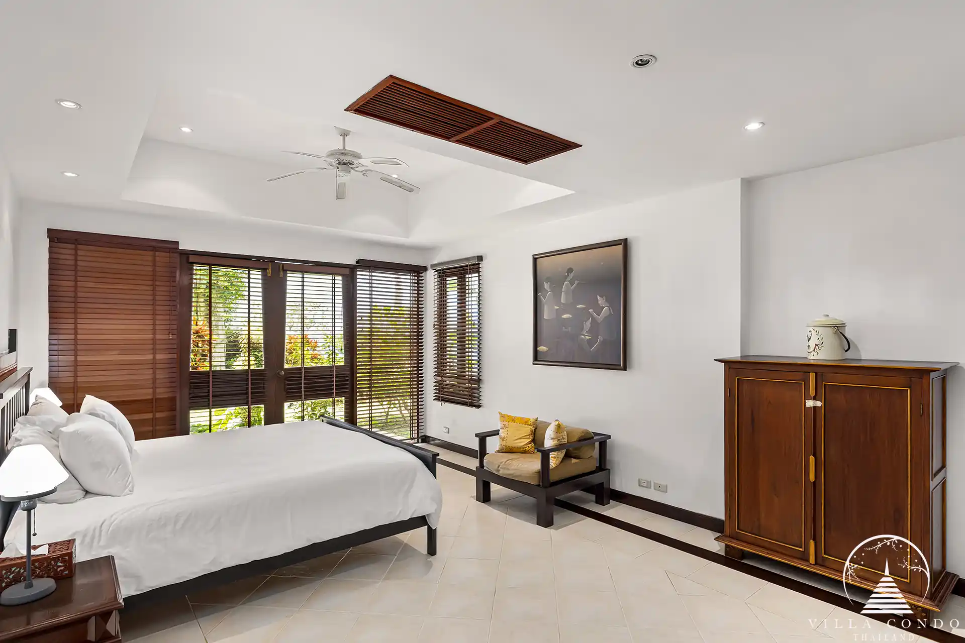 Cozy and elegant bedroom at Nakathani Villa Estate Kamala Beach with garden views.