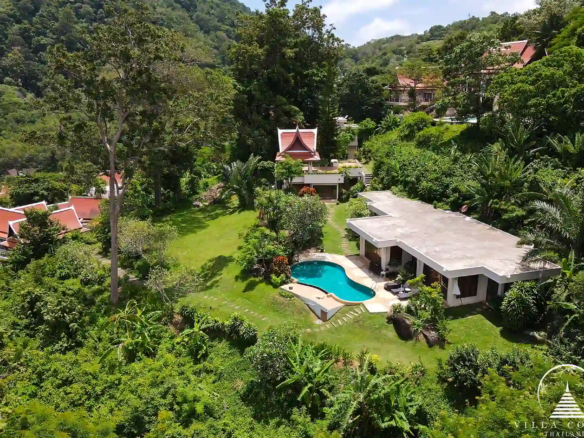 Bird's-eye view of Nakathani Villa Estate Kamala Beach with surrounding greenery and ocean views.